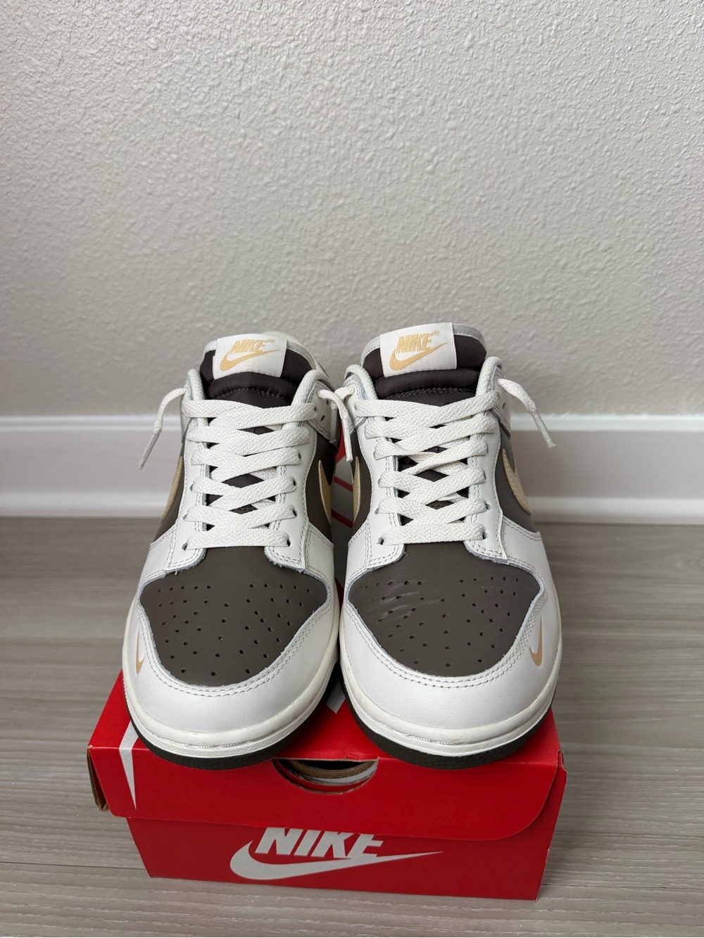 Nike women’s Low-Top Sneakers in White and Brown with Gold Swoosh